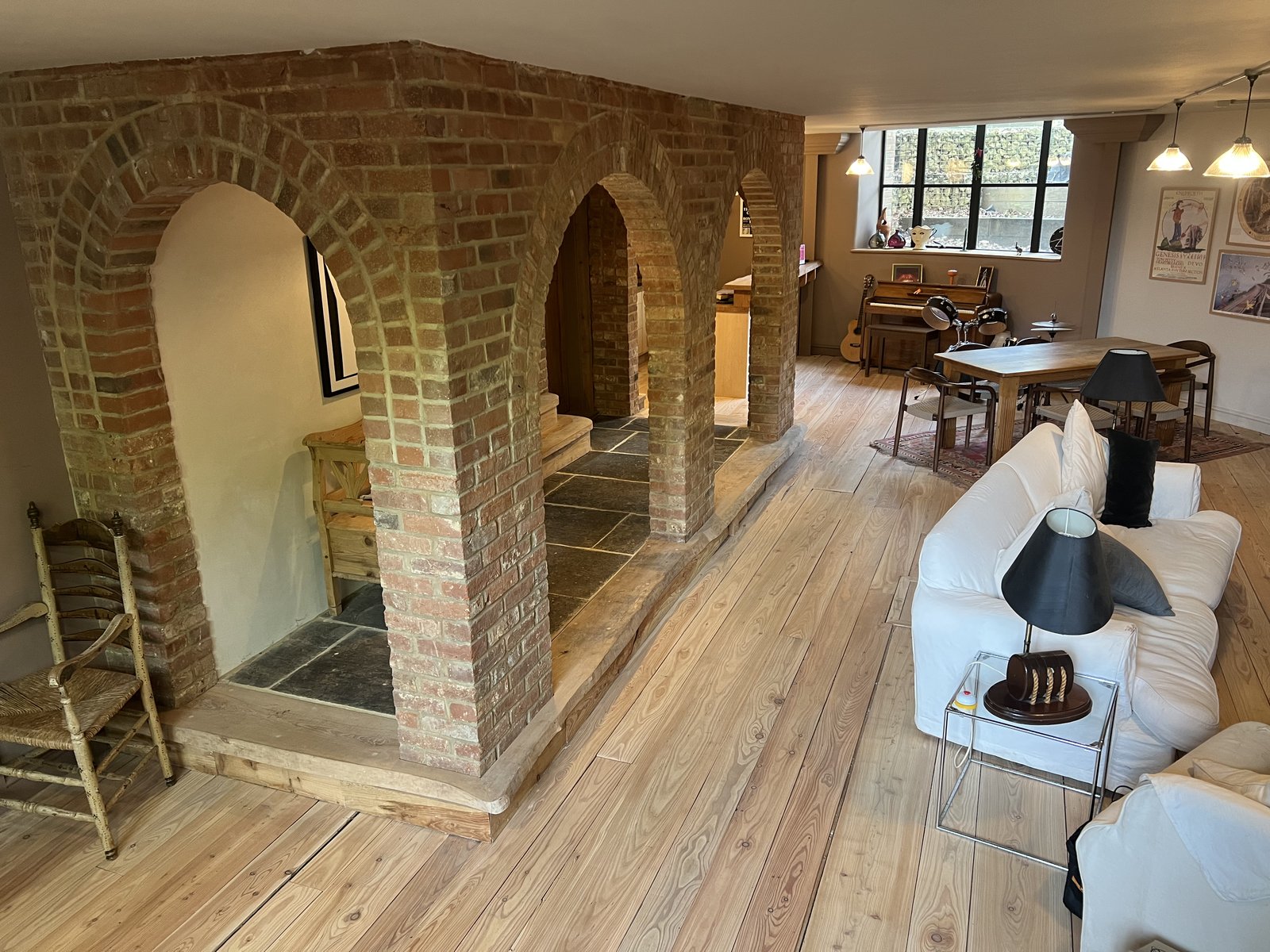 Lower-level basement / workshop space with reclaimed-brick textures