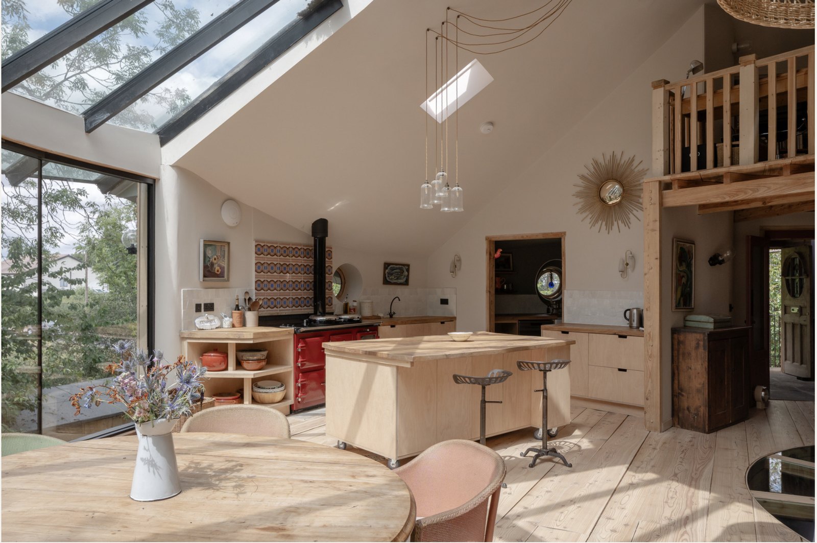 Open-plan kitchen with red Thornhill wood-fired range, zellige-tiled splashback, oak-topped island and skylit beams